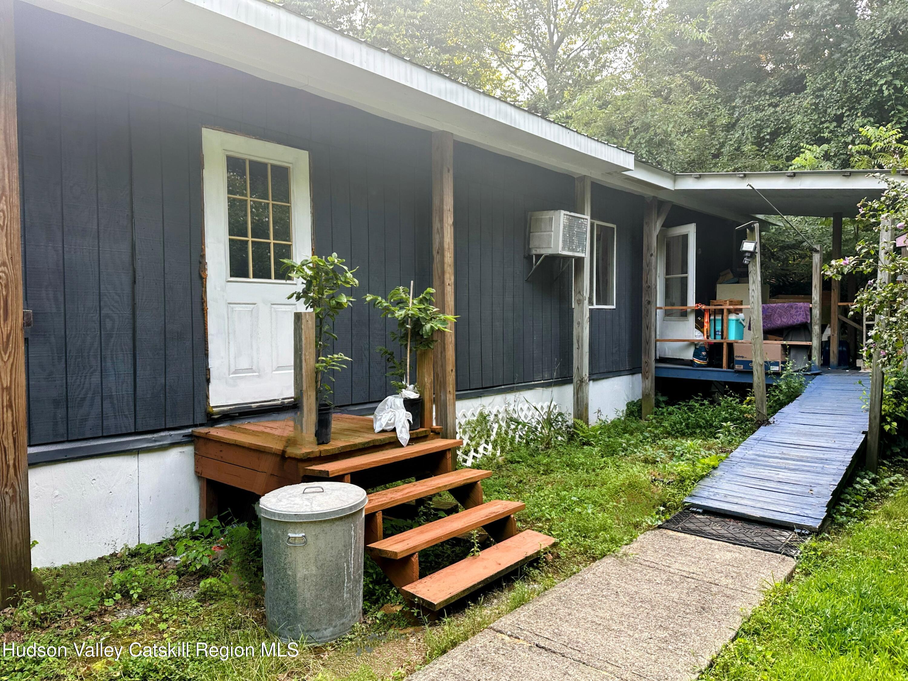 16 Field Road Hudson, NY 12534 - Photo 15 of 24 a front view of a house with a garden