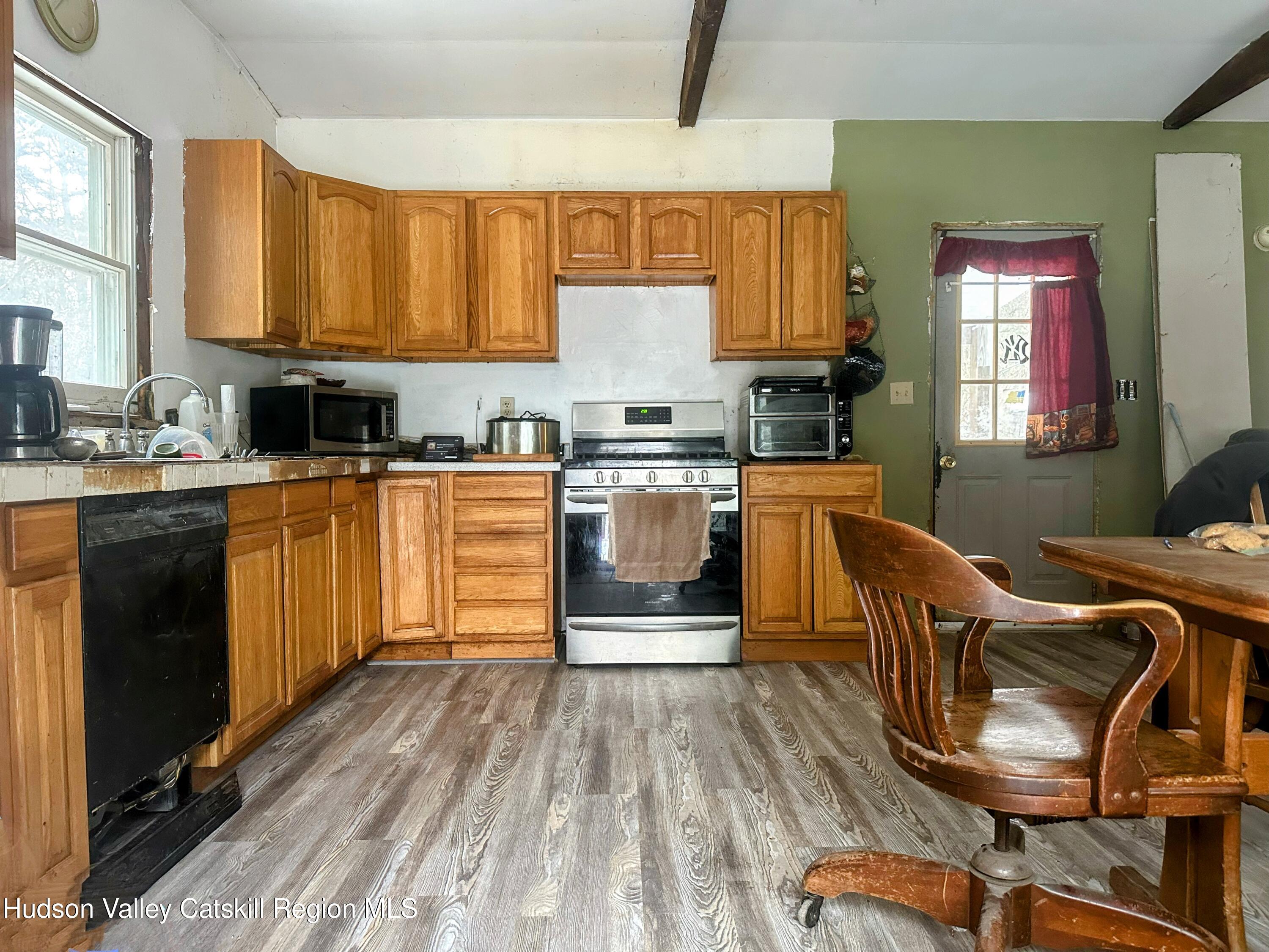 16 Field Road Hudson, NY 12534 - Photo 3 of 24 a kitchen with stainless steel appliances granite countertop a stove top oven a sink dishwasher and cabinets with wooden floor