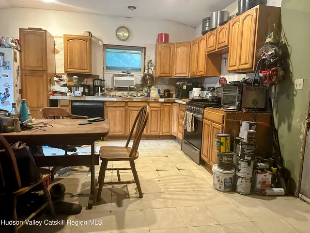 a kitchen with a table chairs and a stove