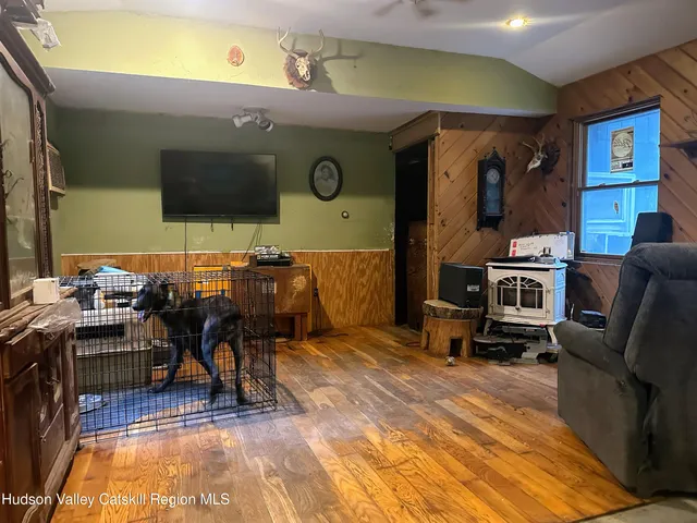a view of a livingroom with furniture and a flat screen tv