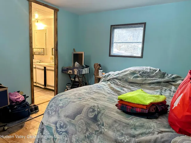 a bed sitting in a bedroom next to a window