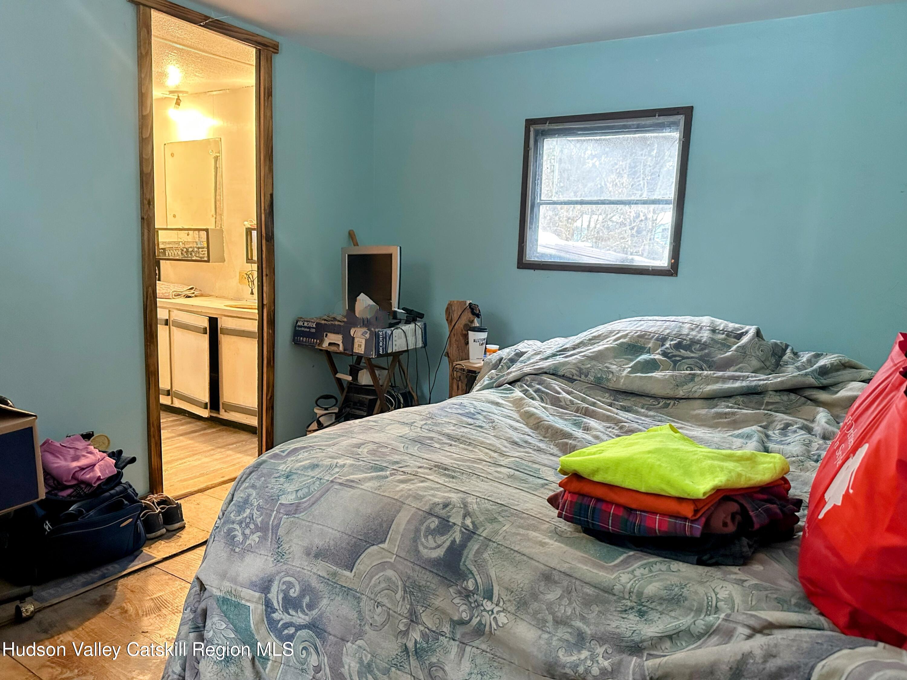 16 Field Road Greenville, NY 12083 - Photo 7 of 22 a bed sitting in a bedroom next to a window
