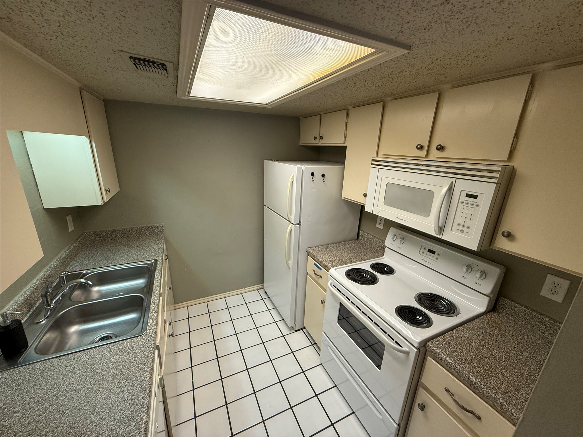 2401 Leon Street, Unit 209 Austin, TX 78705 - Photo 3 of 6 a kitchen with a stove and a refrigerator