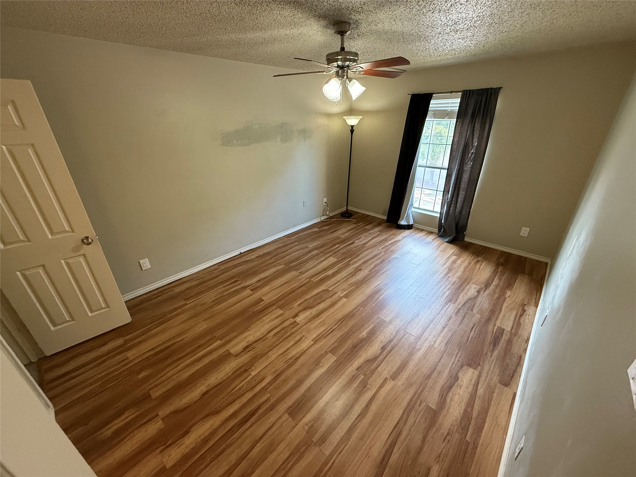 2401 Leon Street, Unit 209 Austin, TX 78705 - Photo 5 of 6 wooden floor in an empty room with a mirror