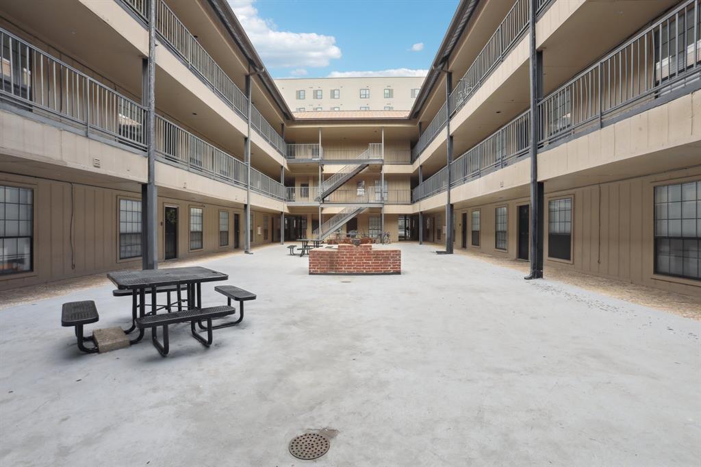 2401 Leon Street, Unit 209 Austin, TX 78705 - Photo 6 of 6 a view of a patio with table and chairs