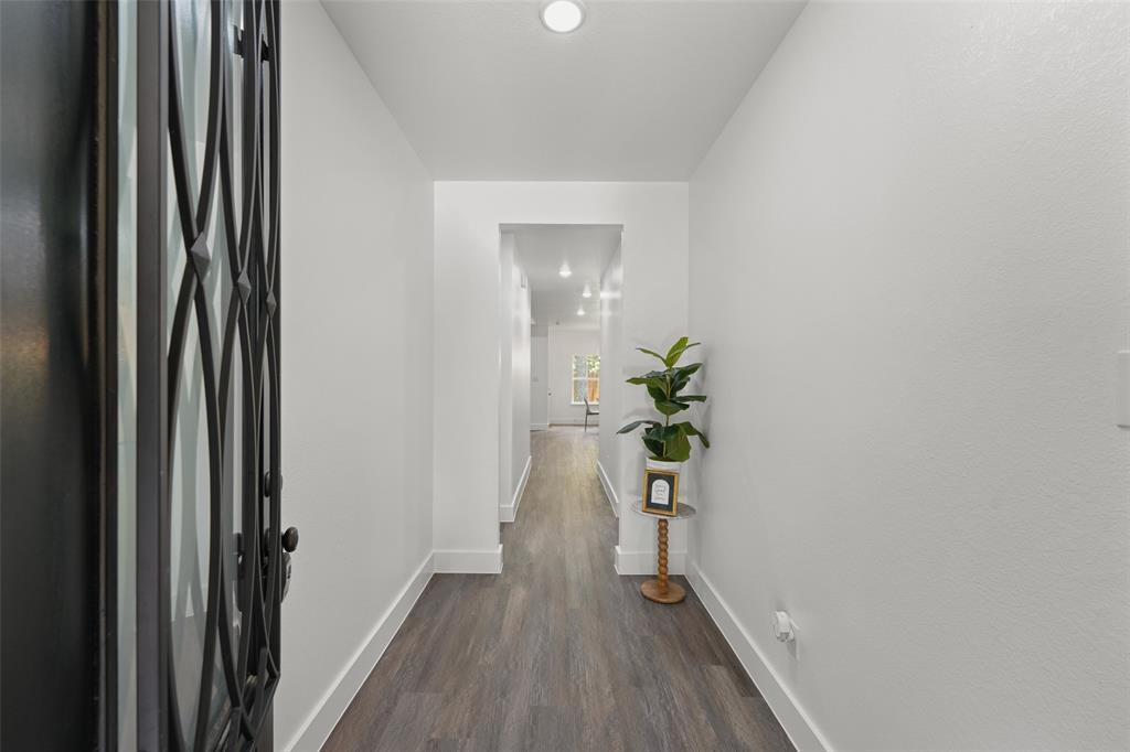 122 East Beachwood Loop Trinidad, TX 75163 - Photo 6 of 35 Entryway featuring a dark metal door with decorative ironwork, white walls, wood-finish flooring, recessed lighting, and white baseboards