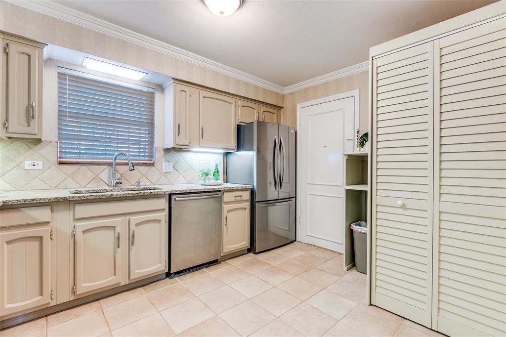 6070 Averill Way, Unit A Dallas, TX 75225 - Photo 11 of 26 a kitchen with granite countertop a white refrigerator oven a sink and dishwasher