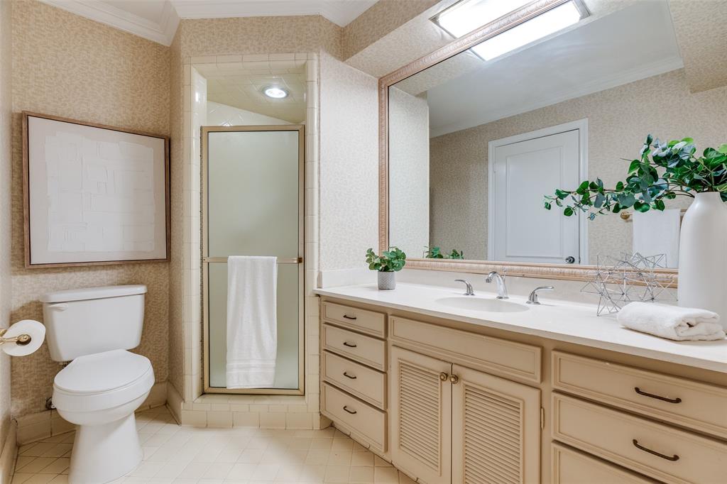 6070 Averill Way, Unit A Dallas, TX 75225 - Photo 14 of 26 a bathroom with a toilet sink and mirror