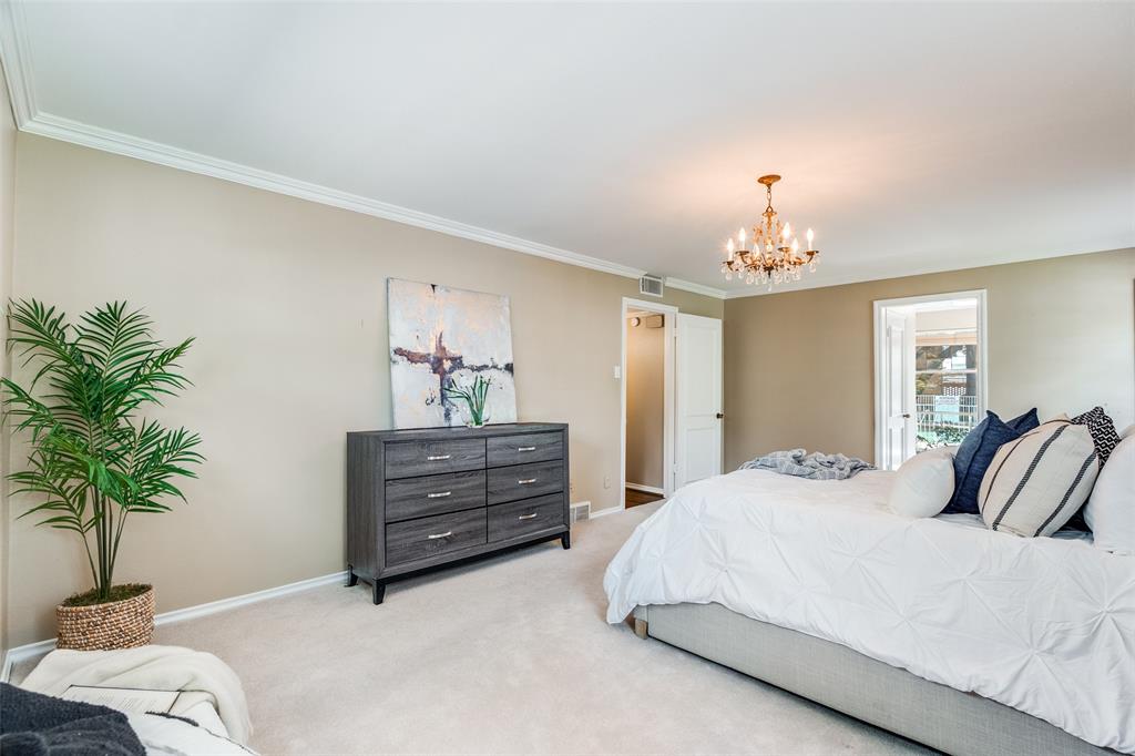 6070 Averill Way, Unit A Dallas, TX 75225 - Photo 16 of 26 a bedroom with bed and a potted plant