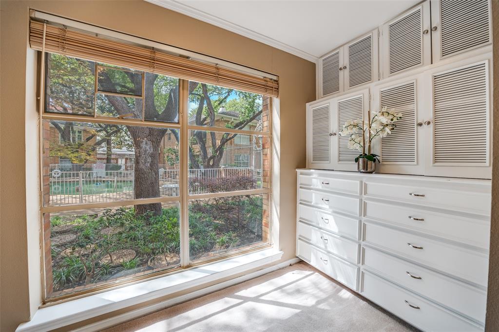 6070 Averill Way, Unit A Dallas, TX 75225 - Photo 18 of 26 a view of a dresser and mirror