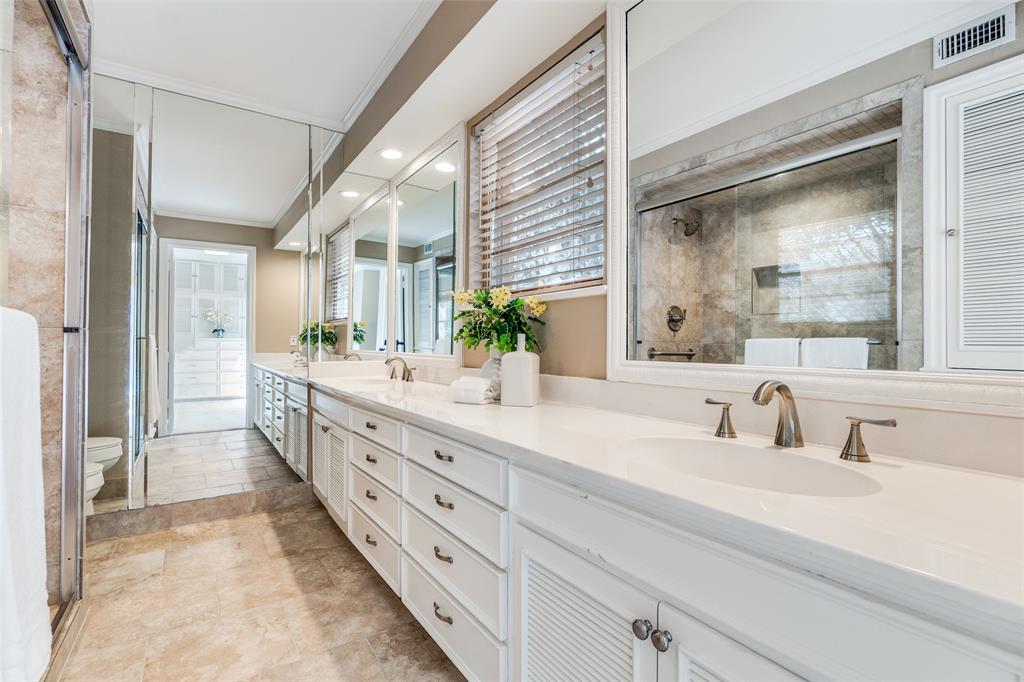 6070 Averill Way, Unit A Dallas, TX 75225 - Photo 19 of 26 a bathroom with double vanity sinks and a large mirror