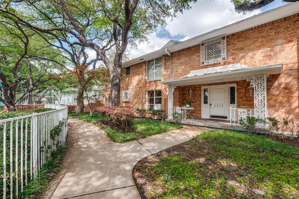 6070 Averill Way, Unit A Dallas, TX 75225 - Photo 24 of 26 a front view of a house with yard and green space