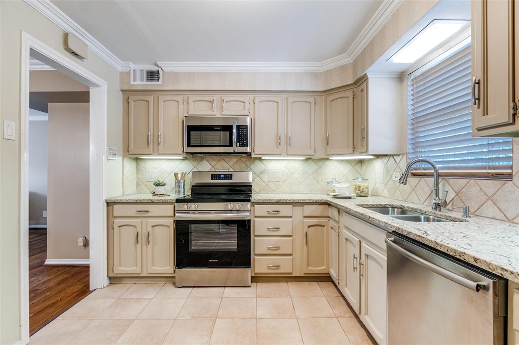 6070 Averill Way, Unit A Dallas, TX 75225 - Photo 9 of 26 a kitchen with a sink stove and microwave