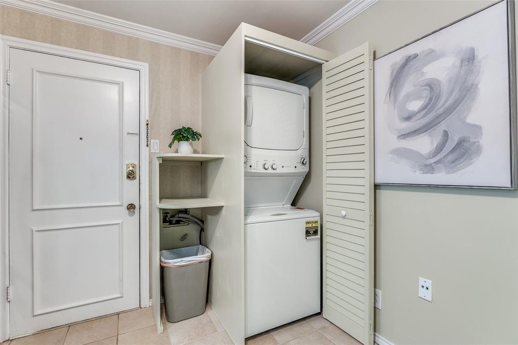 6070 Averill Way, Unit A Dallas, TX 75225 - Photo 10 of 26 a hallway with a washer and dryer