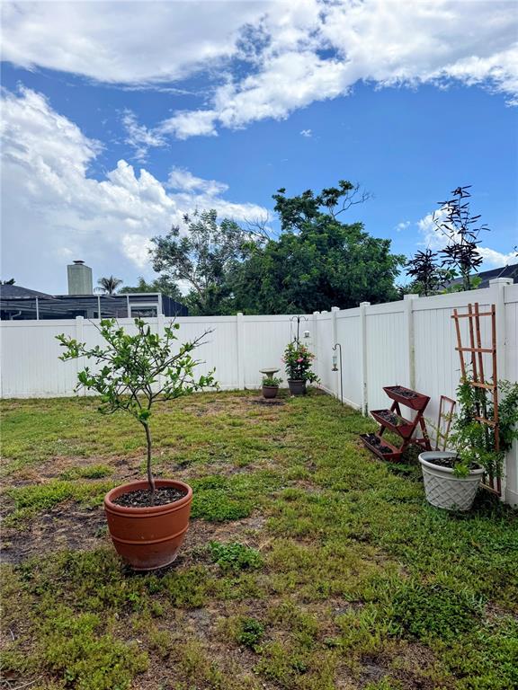 1330 Georgetowne Circle Sarasota, FL 34232 - Photo 45 of 46 a view of a backyard with plants and a fountain