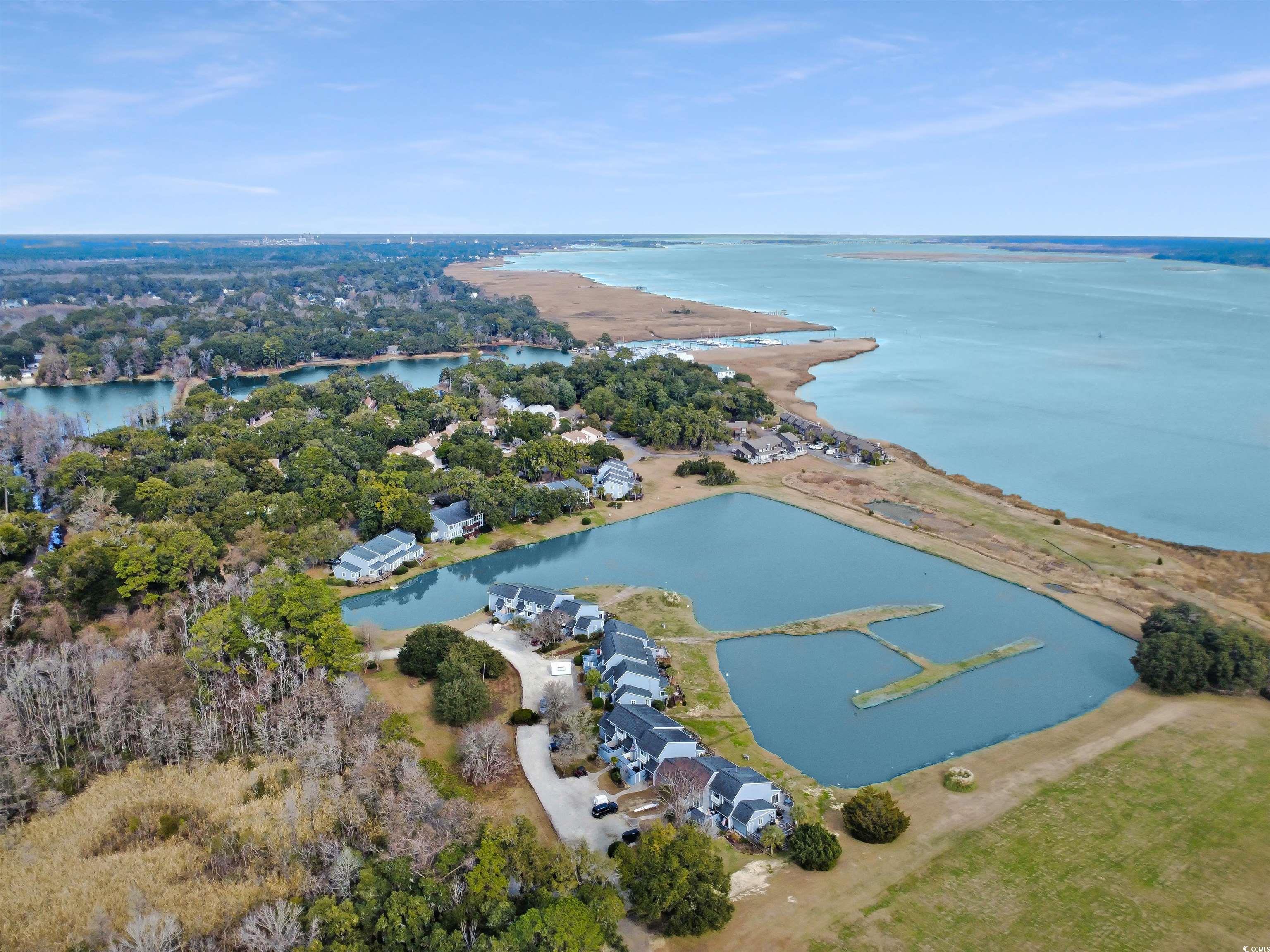 43 Pheasant Loop, Unit 304 Georgetown, SC 29440 - Photo 8 of 38 Aerial view of property and surrounding area with a nearby body of water