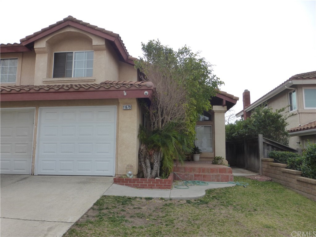 11679 Pescara Road Rancho Cucamonga, CA 91701 - Photo 1 of 1 a view of a house with a yard and garage