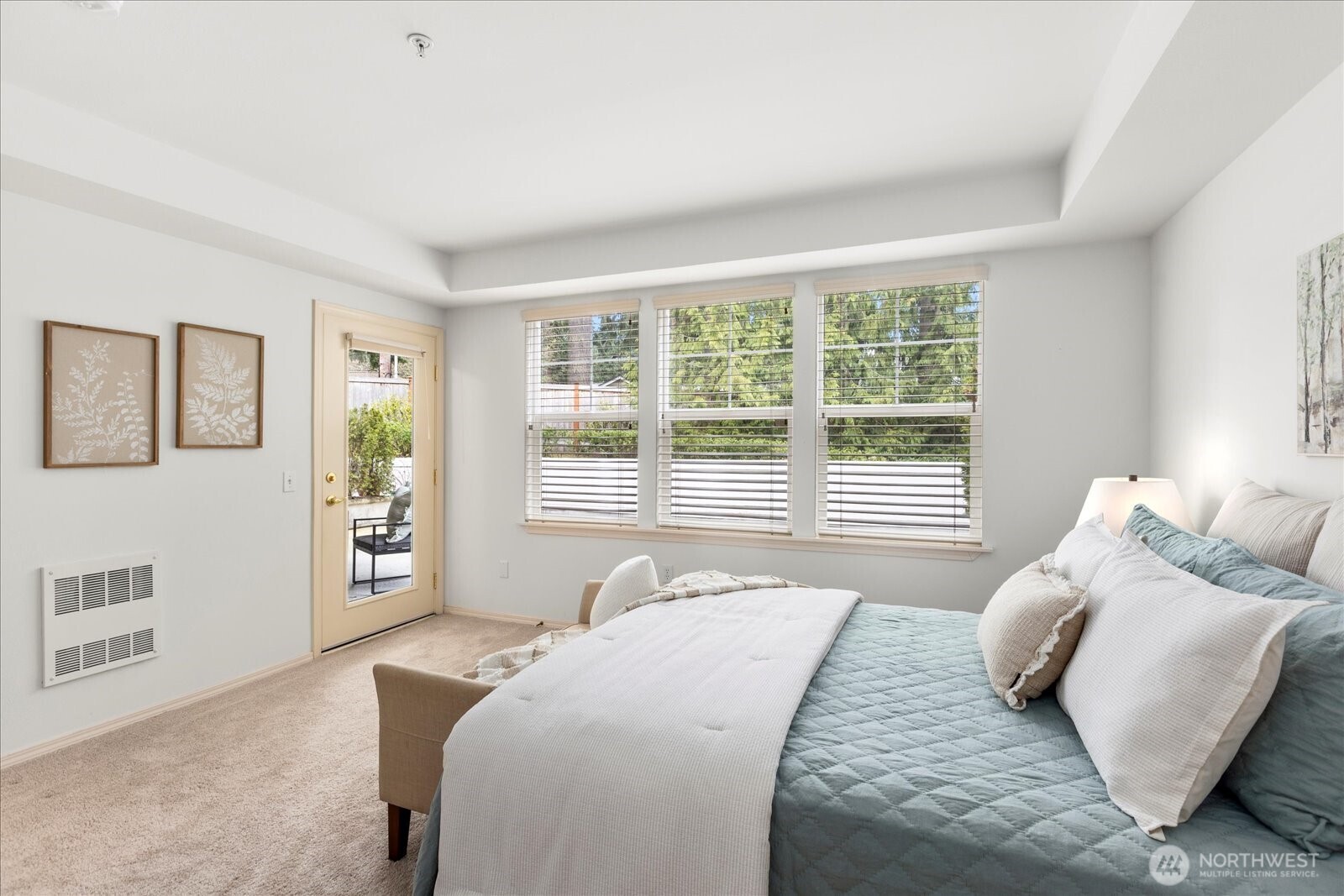8500 Main Street, Unit F205 Edmonds, WA 98026 - Photo 13 of 30 a bedroom with a bed and wooden floor