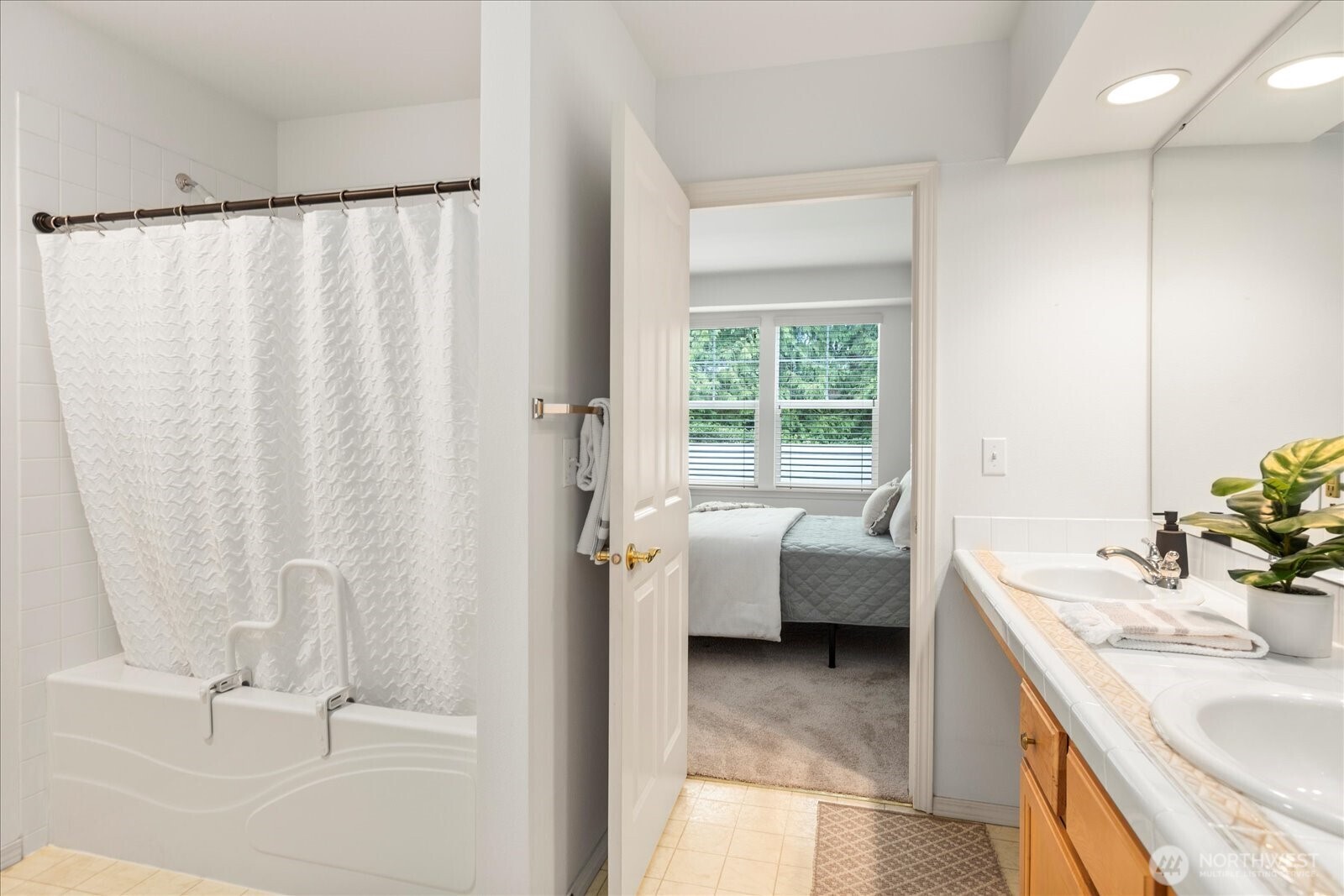 8500 Main Street, Unit F205 Edmonds, WA 98026 - Photo 16 of 30 a bathroom with a sink double vanity and tub
