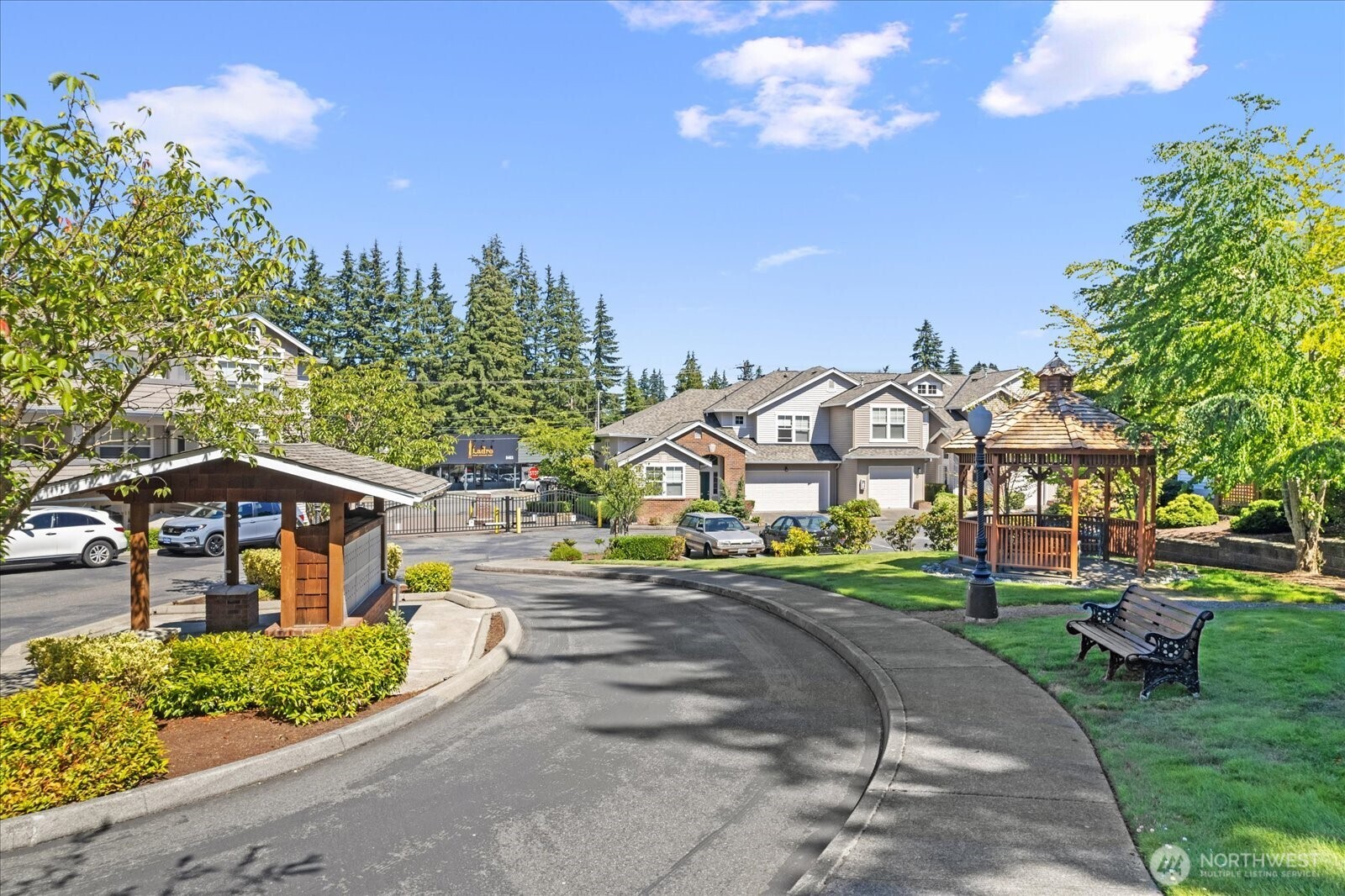 8500 Main Street, Unit F205 Edmonds, WA 98026 - Photo 24 of 30 a view of a big house with a big yard and potted plants
