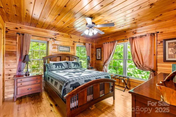 a bedroom with a bed next to a large window with outer view