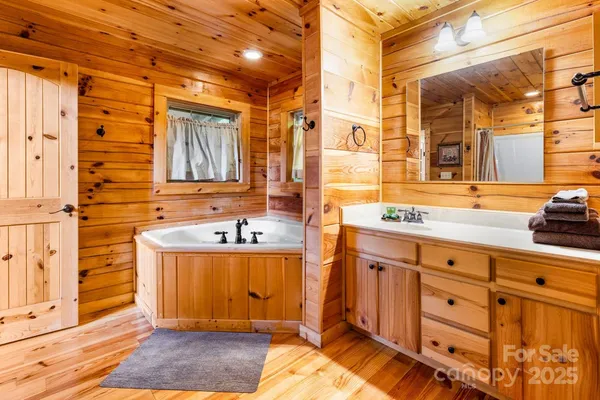 a bathroom with a granite countertop double vanity sink a mirror and a