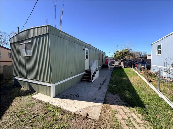 a kitchen with stainless steel appliances granite countertop a sink refrigerator and cabinets