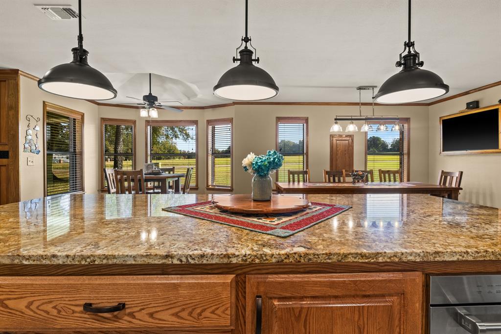78 County Road 2137 Pittsburg, TX 75686 - Photo 14 of 40 a view of a living room and kitchen with a chandelier
