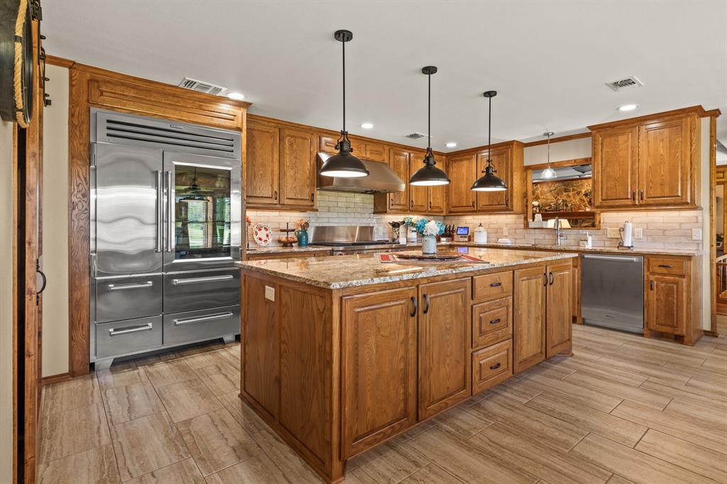 78 County Road 2137 Pittsburg, TX 75686 - Photo 16 of 40 a kitchen with a sink window and stainless steel appliances