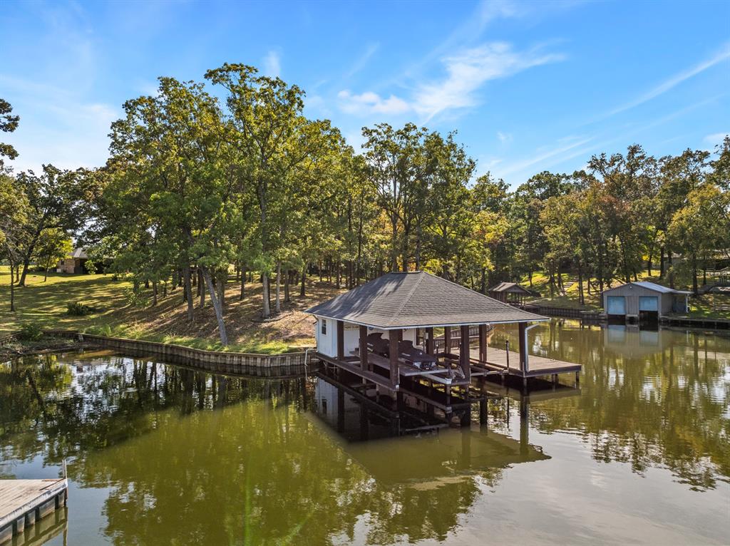 78 County Road 2137 Pittsburg, TX 75686 - Photo 3 of 40 a small pool with lawn chairs under an umbrella