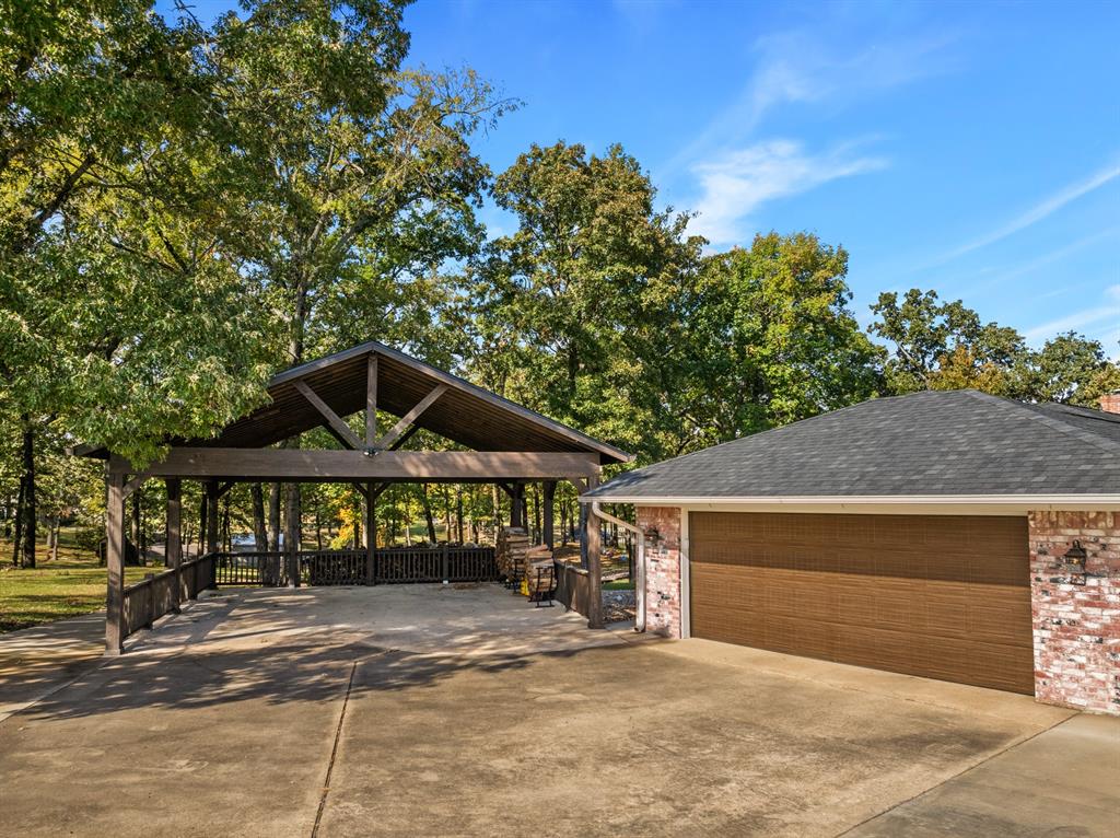 78 County Road 2137 Pittsburg, TX 75686 - Photo 31 of 40 a front view of a house with a yard and garage