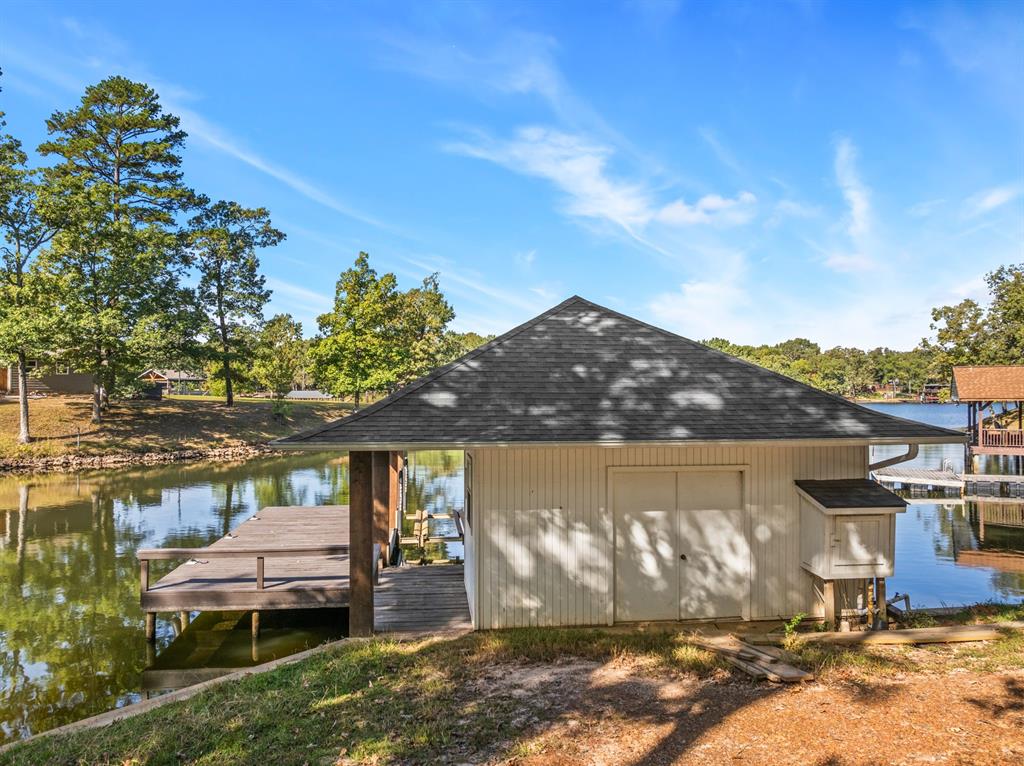 78 County Road 2137 Pittsburg, TX 75686 - Photo 33 of 40 a balcony with furniture and a lake view