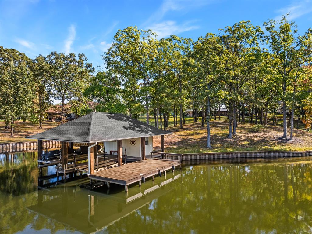 78 County Road 2137 Pittsburg, TX 75686 - Photo 35 of 40 a small pool with lawn chairs under an umbrella