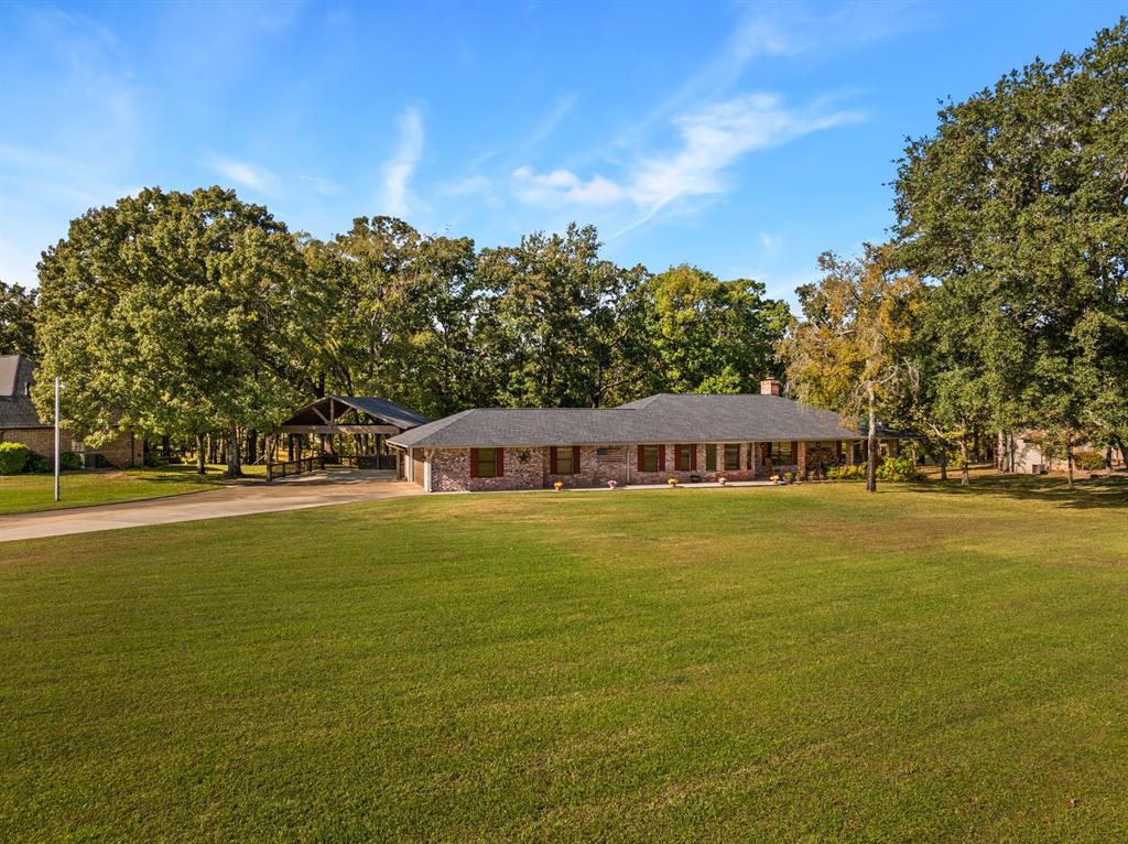 78 County Road 2137 Pittsburg, TX 75686 - Photo 4 of 40 a front view of a house with a garden