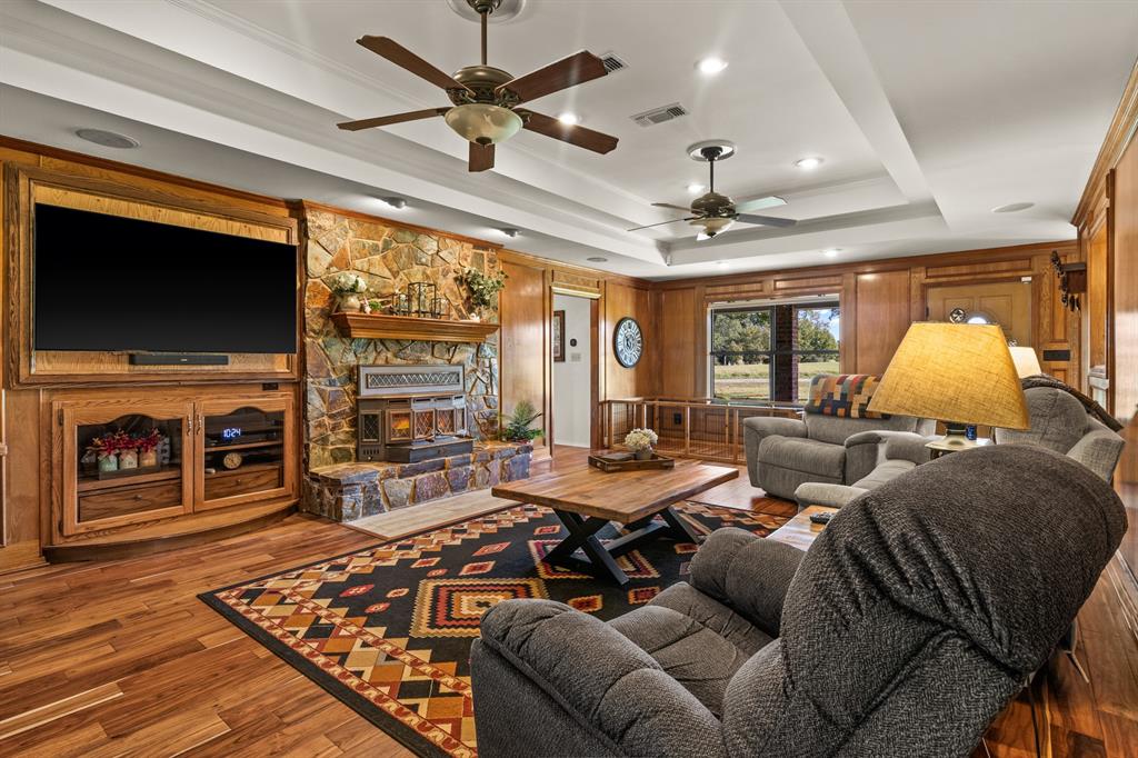 78 County Road 2137 Pittsburg, TX 75686 - Photo 8 of 40 a living room with fireplace furniture and a flat screen tv