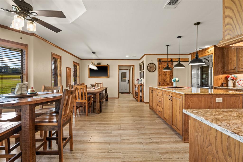 78 County Road 2137 Pittsburg, TX 75686 - Photo 10 of 40 a view of a kitchen with kitchen island wooden floor center island and stainless steel appliances