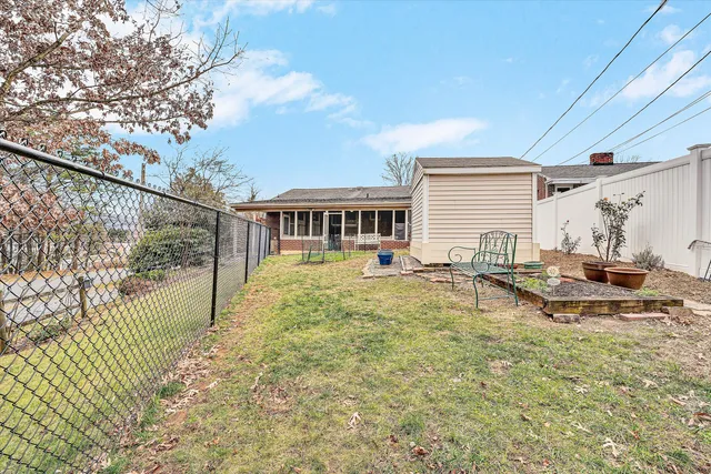 a view of a house with pool and sitting area