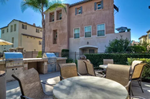a view of a patio with couches table and chairs with potted plants