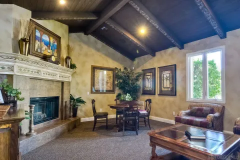 a living room with furniture a fireplace and a flat screen tv