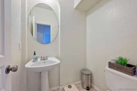 a bathroom with a toilet a sink and mirror