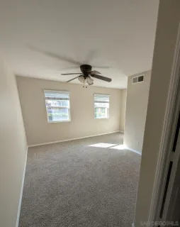an empty room with windows and closet