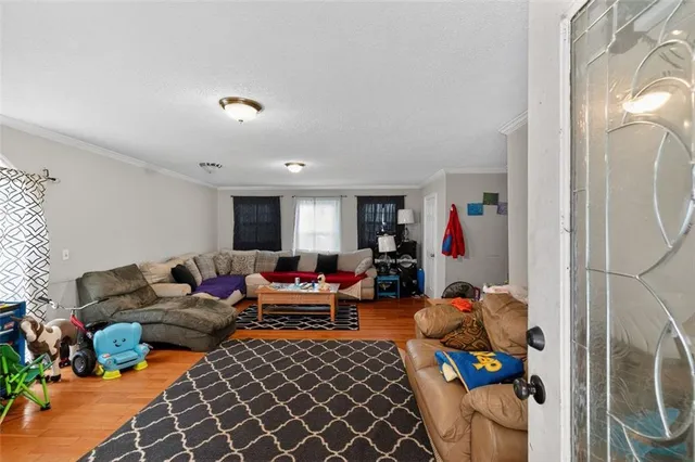 a living room with furniture a rug and a flat screen tv