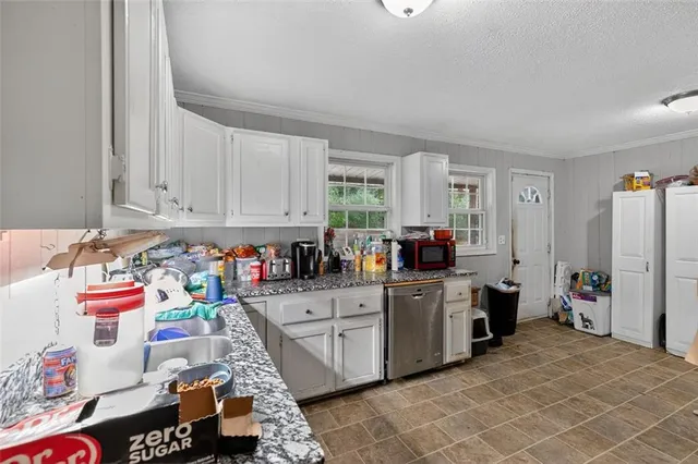 a kitchen with stainless steel appliances a stove a sink and a refrigerator