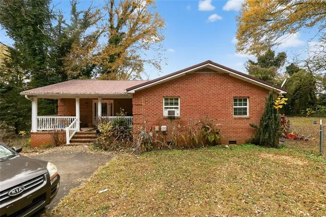 a front view of house with yard outdoor seating and barbeque oven