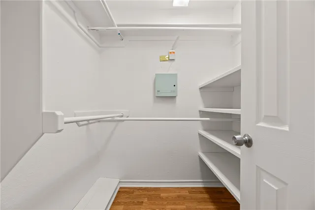 a view of walk in closet with empty racks
