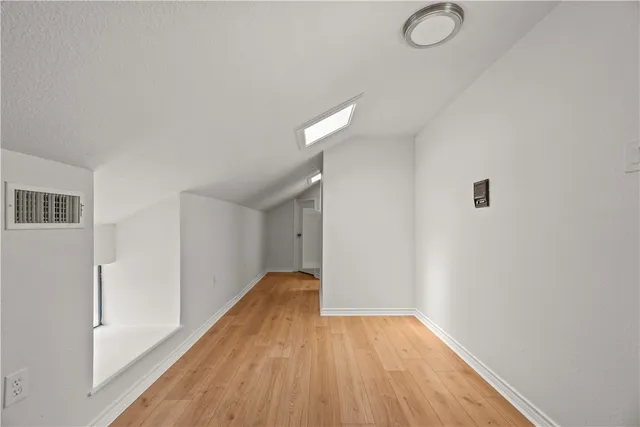 a view of hallway with wooden floor