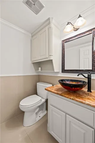 a bathroom with a toilet a sink and a mirror