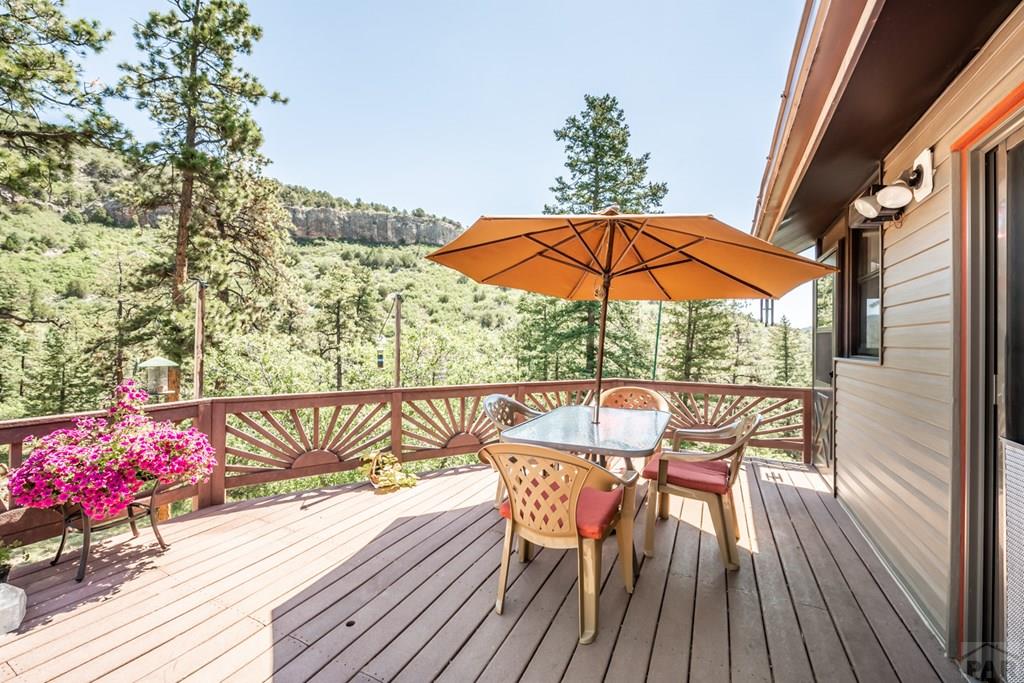 9600 Middle Creek Canyon Road Beulah, CO 81023 - Photo 4 of 50 a view of a chairs and table in the wooden floor