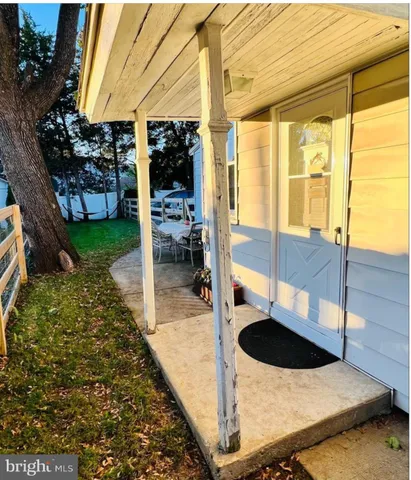 a living room with a rug floor and a floor to ceiling window