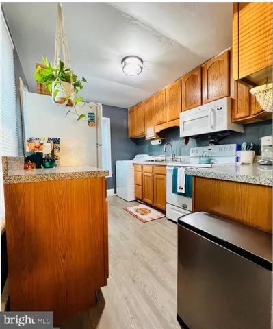 a kitchen with stainless steel appliances granite countertop a refrigerator